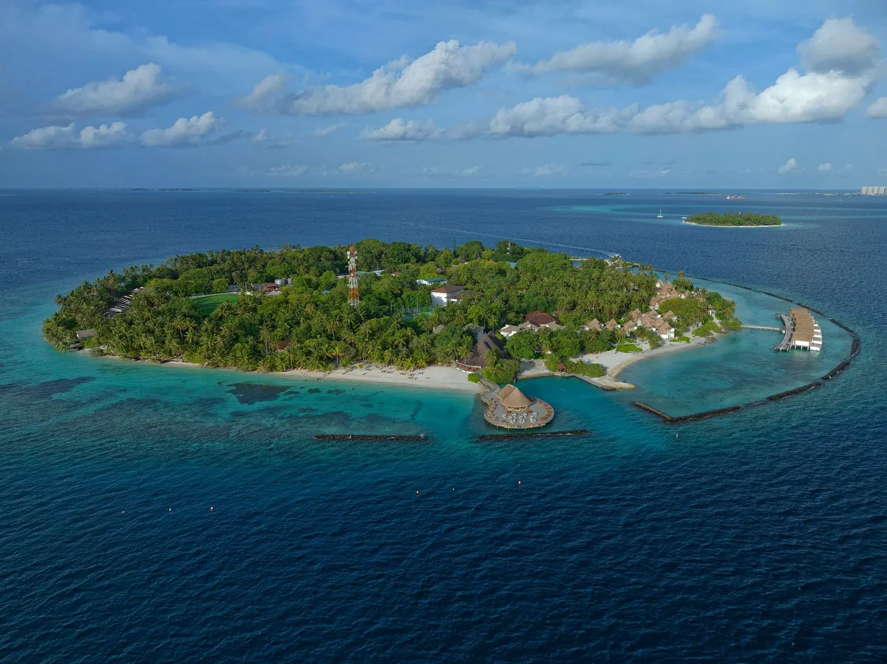 Aerial view of Bandos Maldives island resort surrounded by blue lagoon