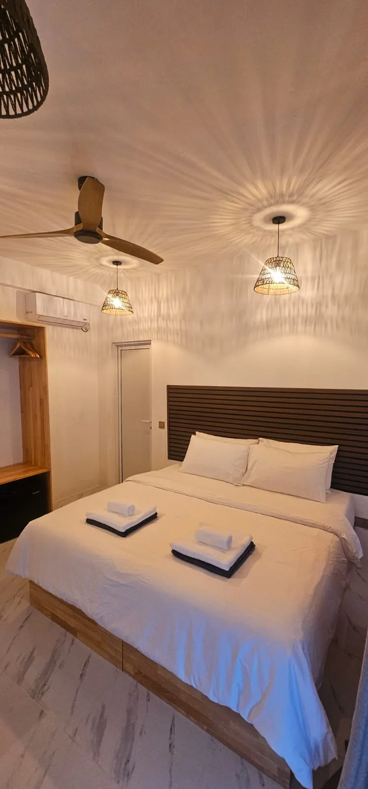 Guest room with double bed and wooden wardrobe at Ale Sara Guest House on Thoddoo, Maldives