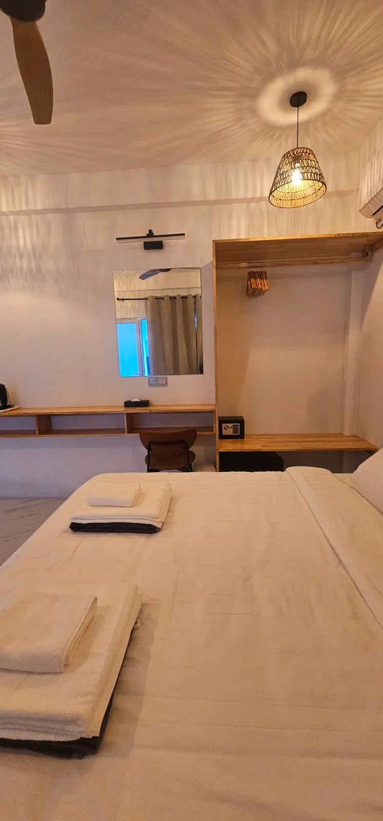 Guest room with double bed, wooden wardrobe and desk at Ale Sara Guest House on Thoddoo, Maldives