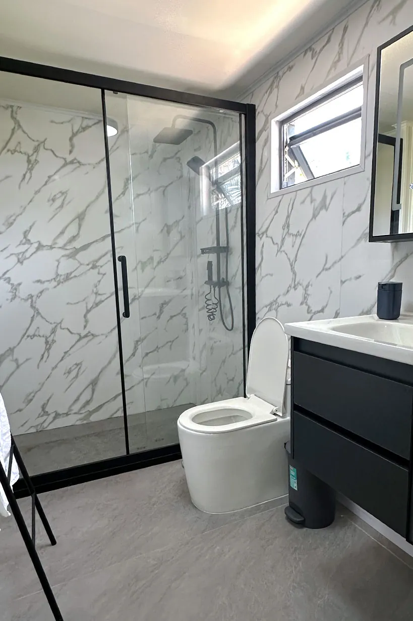 Marble-tiled bathroom with a walk-in shower at Ambra Maldives, Thoddoo
