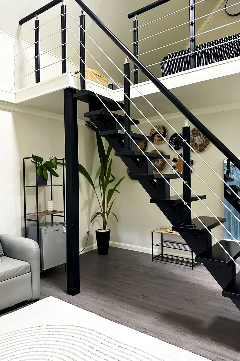 Staircase and seating area inside a villa at Ambra Maldives, Thoddoo