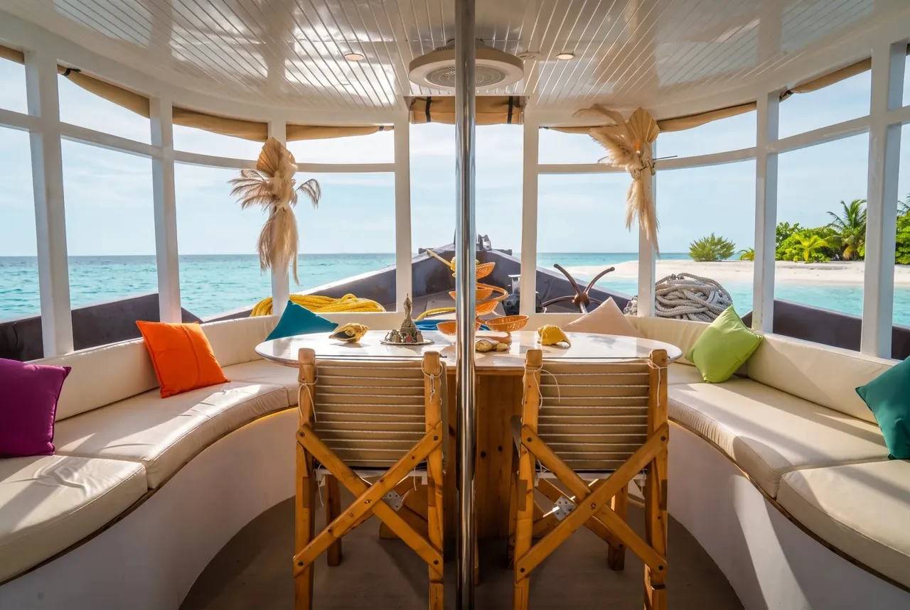 Lounge and dining area with sea views on the Atoll Villa yacht