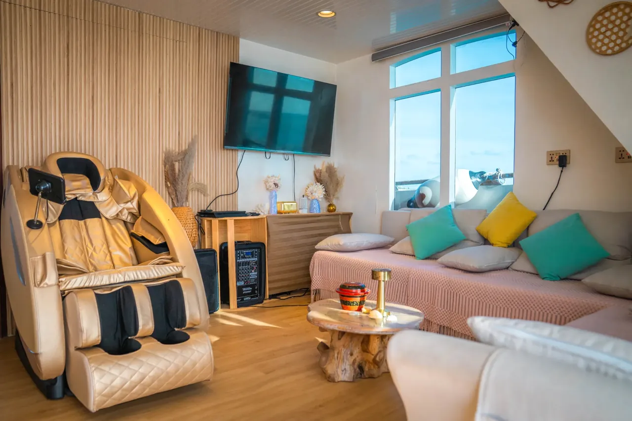 Saloon lounge with massage chair on the Atoll Villa yacht