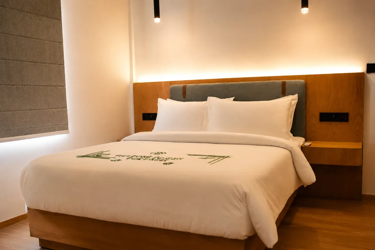Bedroom with wooden headboard and reading lights at Cozy Nest Fuvahmulah
