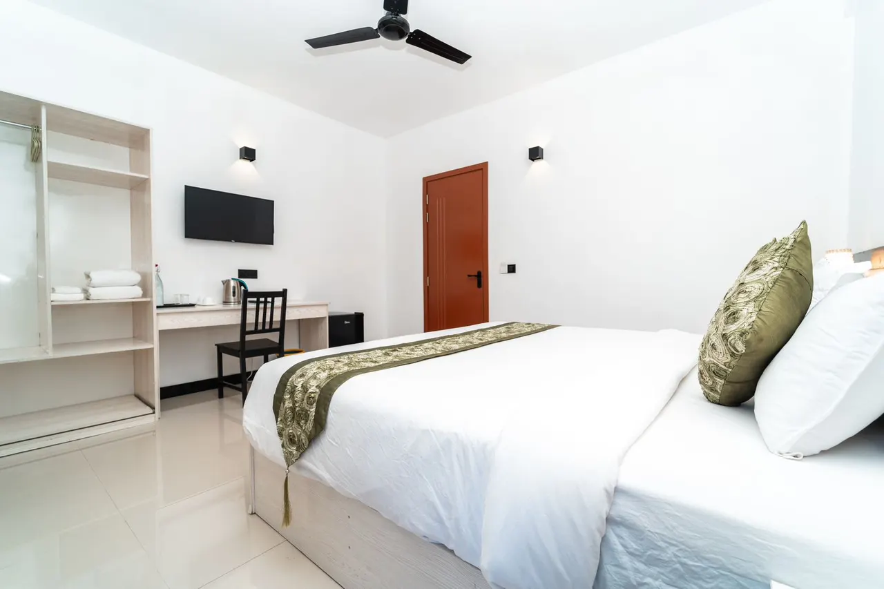 Double Deluxe room with wardrobe and desk area at Cozy Roots Fuvahmulah