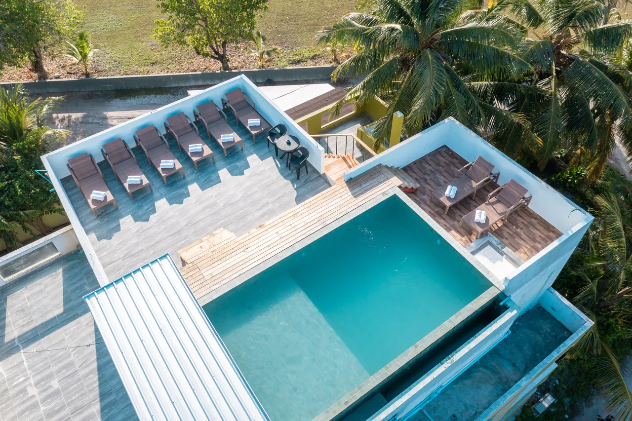 Rooftop pool with loungers at Cozy Roots, Fuvahmulah