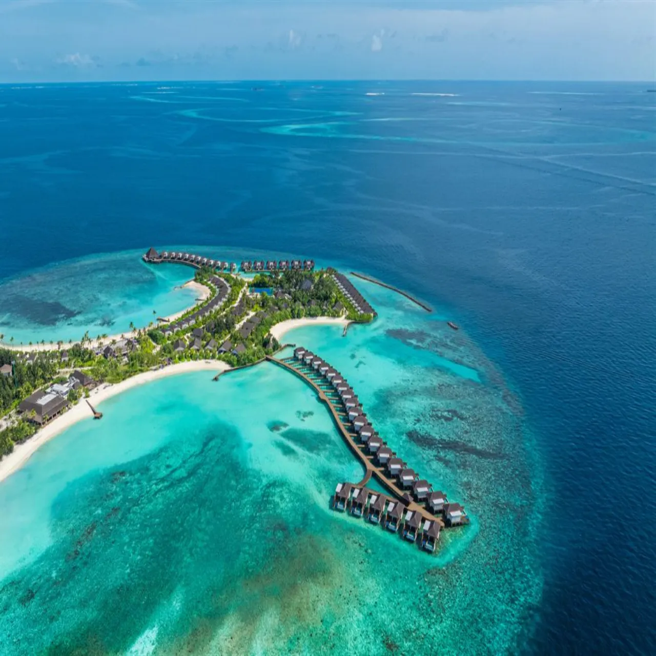 Aerial view of dusitD2 Feydhoo Maldives, with the island resort surrounded by turquoise water