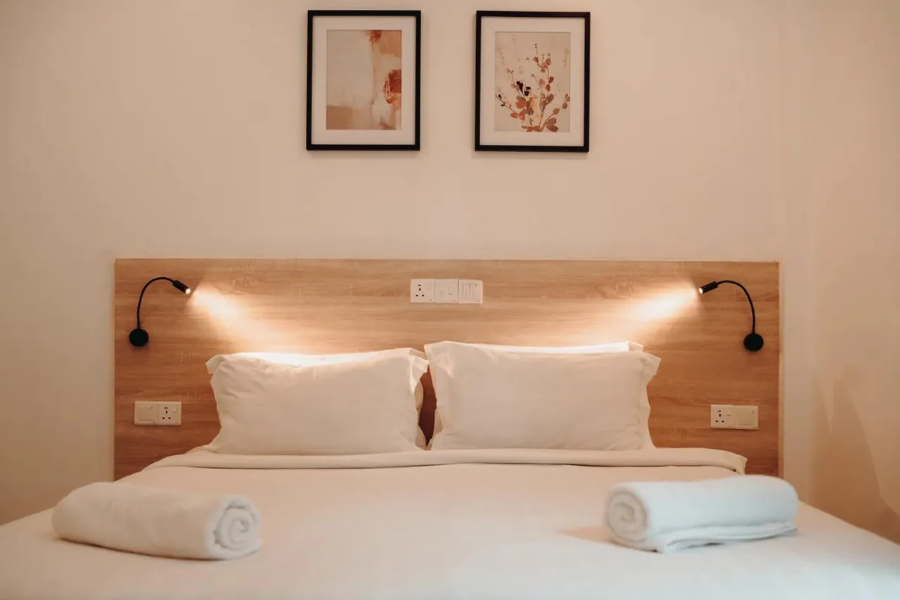 Double room with reading lights at Nala Island Village, Maafushi