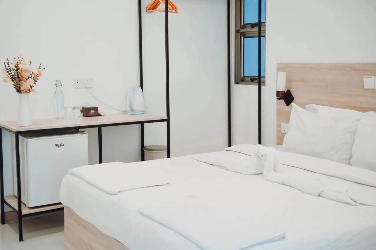 Double room with desk and mini fridge at Nala Island Village, Maafushi