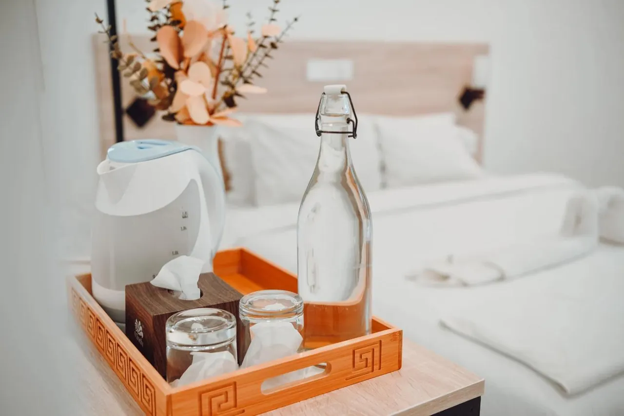 Tea and water tray in a room at Nala Island Village, Maafushi