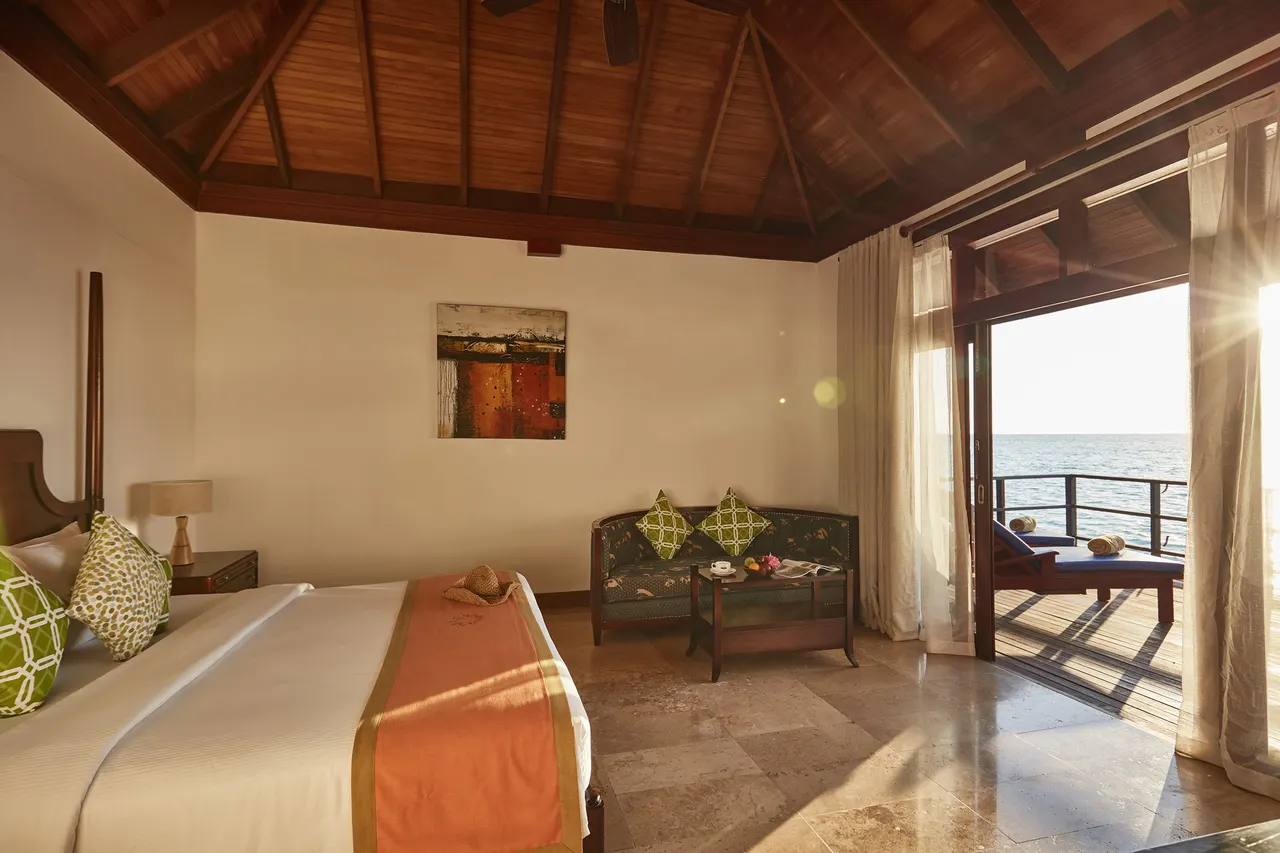 Deluxe water villa bedroom at Sun Siyam Olhuveli, Maldives