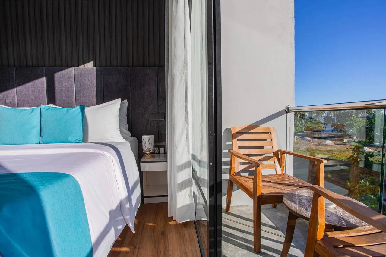 Guest room with a private balcony at Whaleshark Beach, Dhigurah