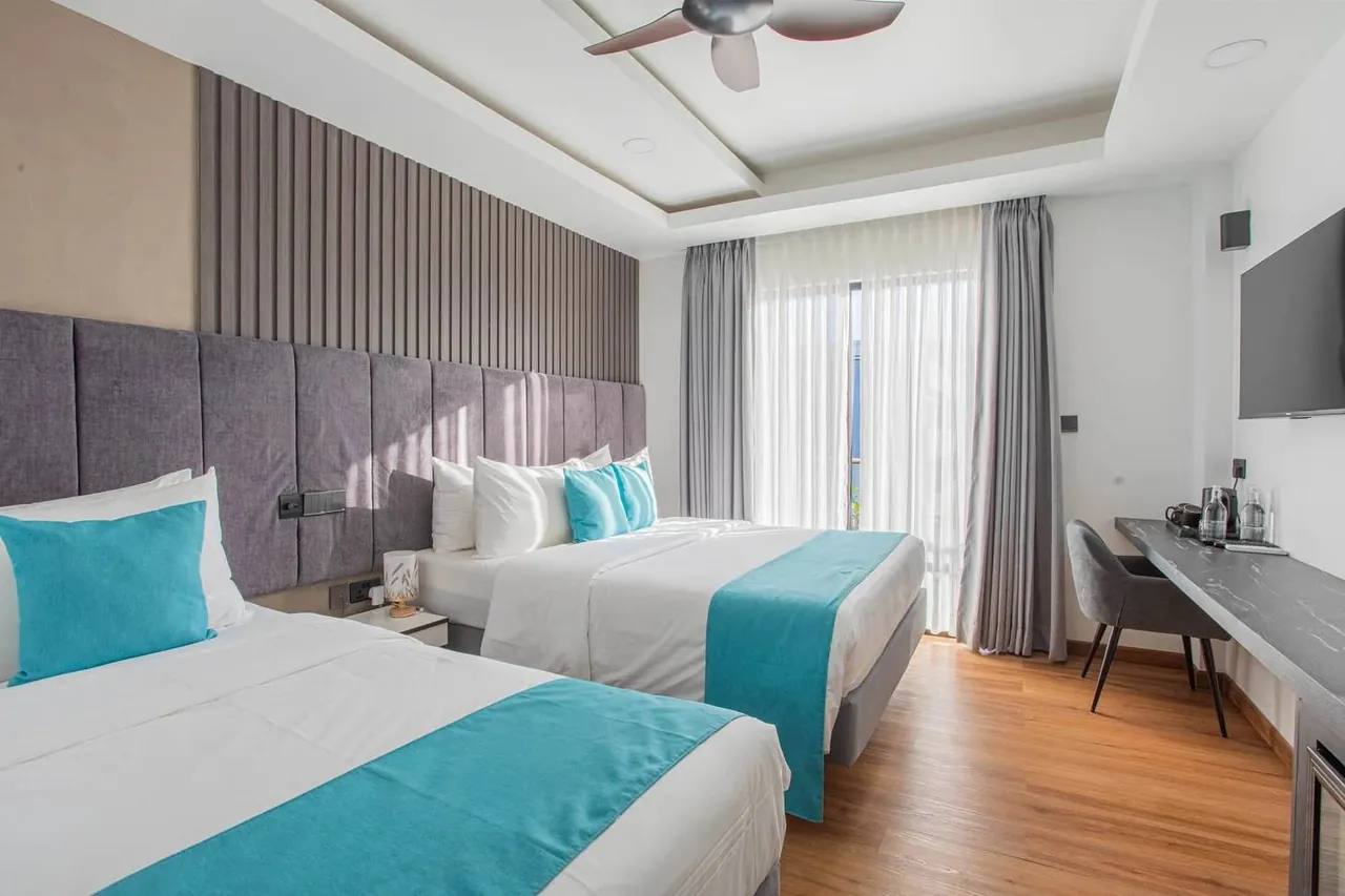 Guest room with desk and TV at Whaleshark Beach, Dhigurah