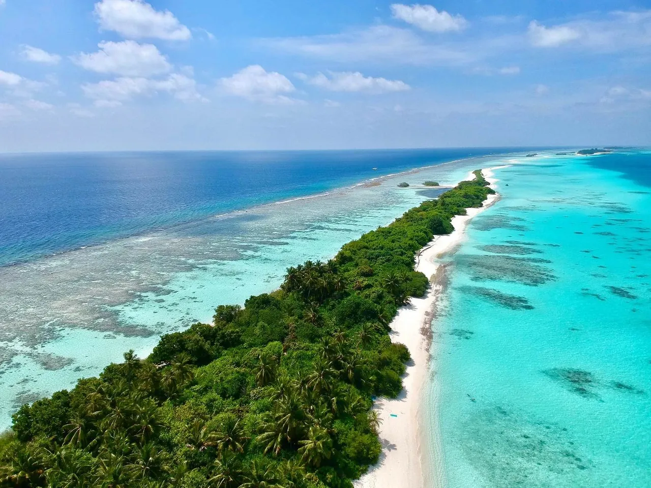 Aerial view of Dhigurah island and its long white beach, South Ari Atoll